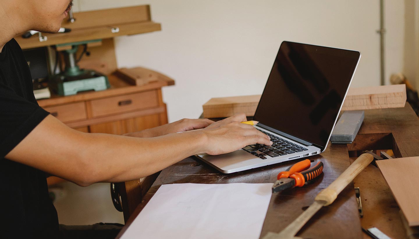 Epoxy Flooring Business man at laptop in shop